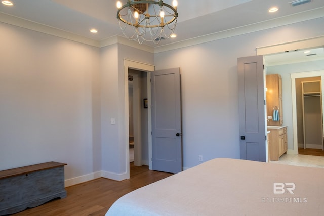 bedroom featuring ornamental molding, recessed lighting, baseboards, and wood finished floors