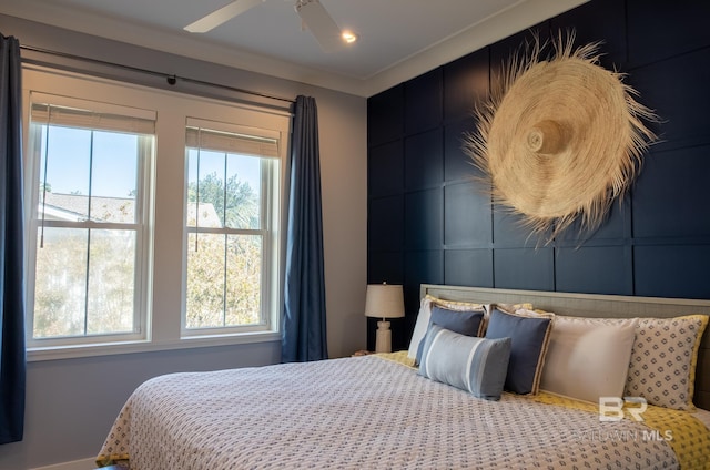 bedroom with multiple windows, a decorative wall, a ceiling fan, and recessed lighting