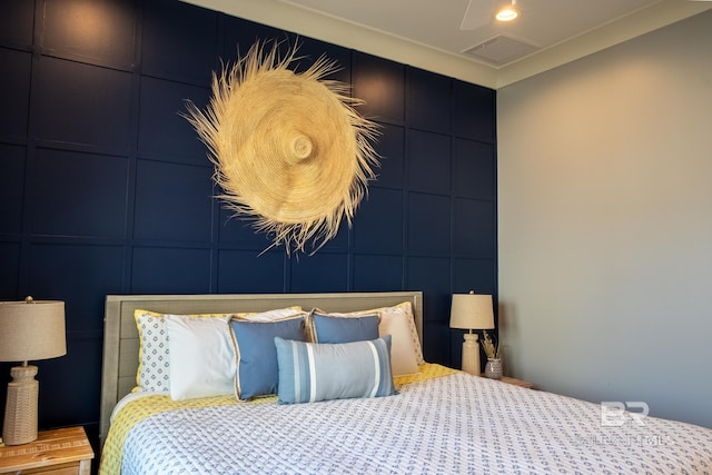 bedroom with recessed lighting, visible vents, and a decorative wall