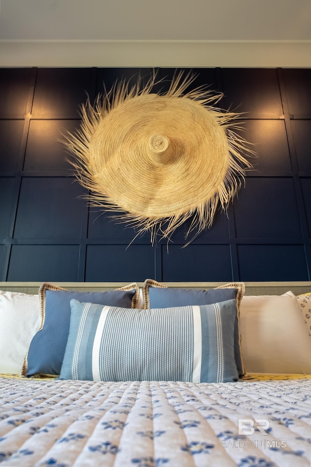 bedroom featuring a decorative wall