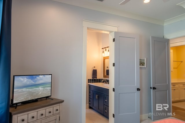 interior space featuring ensuite bath, ornamental molding, and recessed lighting