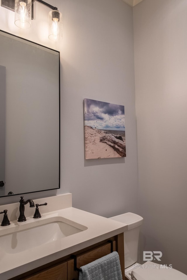 half bathroom featuring toilet and vanity