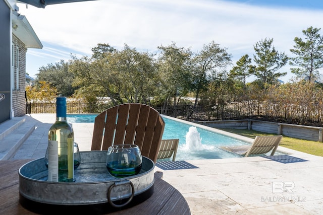 view of pool with a fenced in pool, a fenced backyard, and a patio