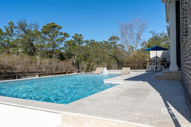 view of swimming pool featuring a patio area, fence, and a fenced in pool