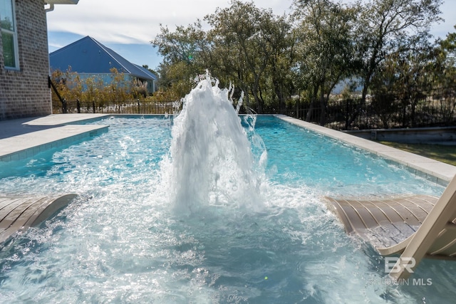 view of swimming pool with a fenced in pool and fence