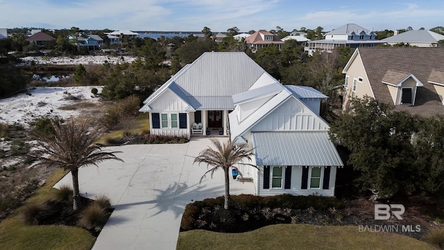 view of front facade with board and batten siding and metal roof