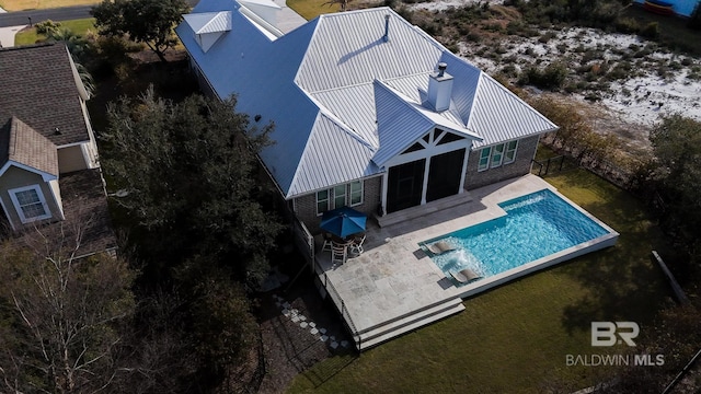 pool with a patio and a yard