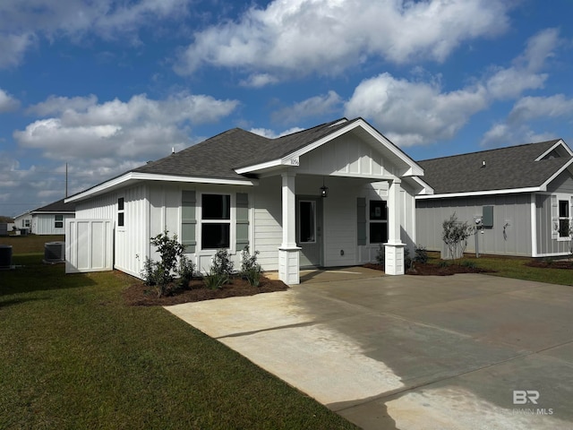 view of front facade with a front lawn and central AC unit