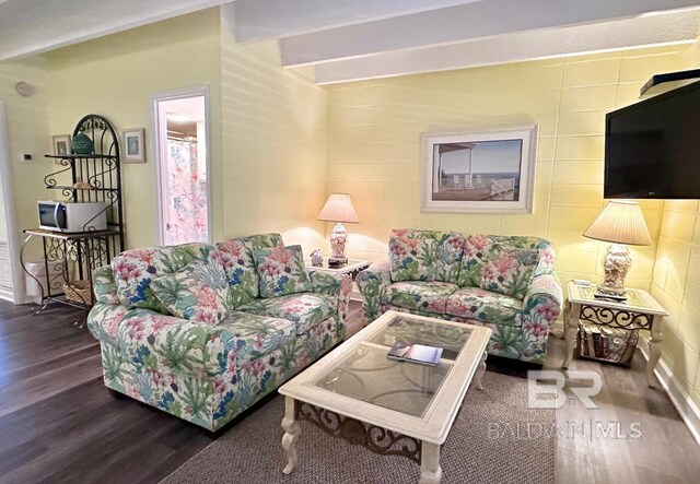 living room featuring ceiling fan, wood-type flooring, and a textured ceiling