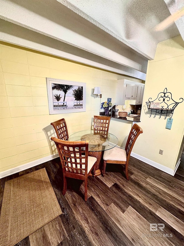 dining room with dark hardwood / wood-style flooring and a textured ceiling