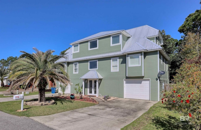 4209 Antigua Ct, Orange Beach, AL 36561 - coastal home featuring metal roof, an attached garage, french doors, and concrete driveway