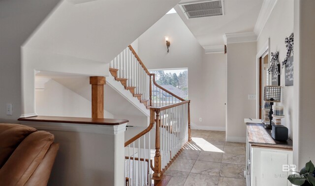 4209 Antigua Ct, Orange Beach, AL 36561 - stairway with baseboards, visible vents, crown molding, and lofted ceiling