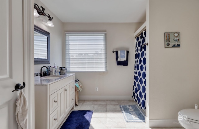 4209 Antigua Ct, Orange Beach, AL 36561 - bathroom with a shower with shower curtain, toilet, vanity, tile patterned flooring, and baseboards