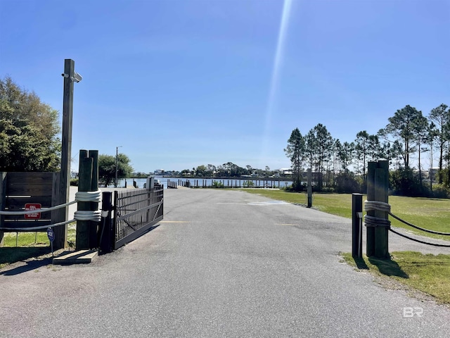 4209 Antigua Ct, Orange Beach, AL 36561 - view of road featuring driveway, a gate, a water view, and a gated entry