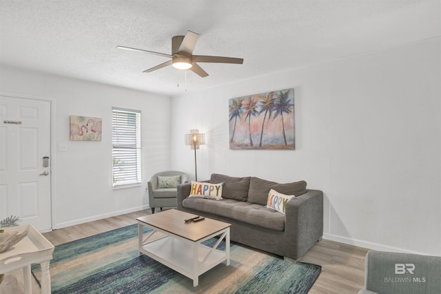 325 E 22nd Ave Unit 8, Gulf Shores, AL 36542 - living area featuring wood finished floors, ceiling fan, baseboards, and a textured ceiling
