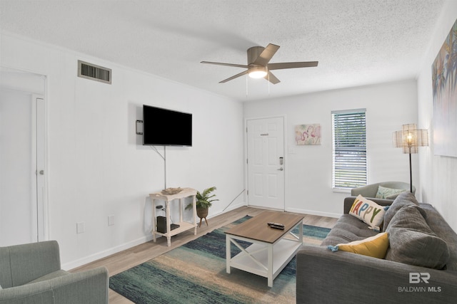 325 E 22nd Ave Unit 8, Gulf Shores, AL 36542 - living room featuring a ceiling fan, a textured ceiling, wood finished floors, and baseboards