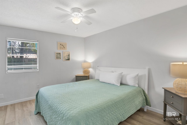 325 E 22nd Ave Unit 8, Gulf Shores, AL 36542 - bedroom with wood finished floors, baseboards, and ceiling fan