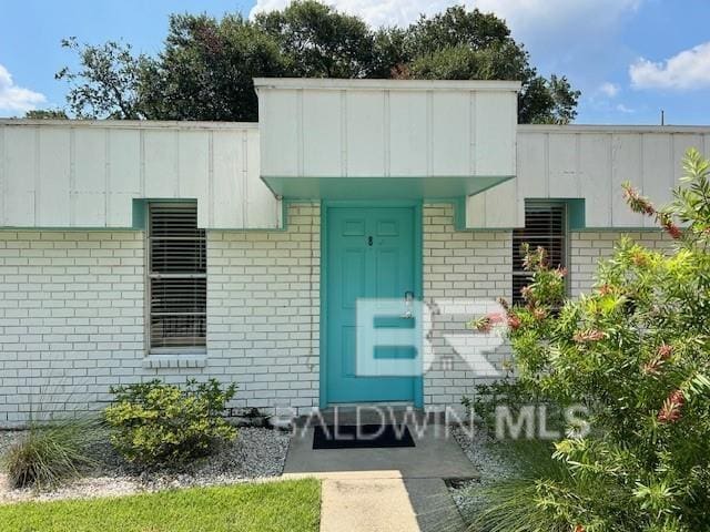325 E 22nd Ave Unit 8, Gulf Shores, AL 36542 - property entrance featuring board and batten siding and brick siding