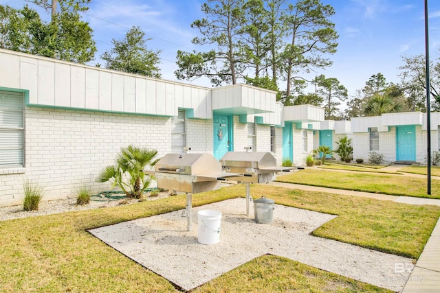 325 E 22nd Ave Unit 8, Gulf Shores, AL 36542 - view of front of property featuring brick siding and a front lawn