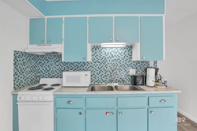 325 E 22nd Ave Unit 8, Gulf Shores, AL 36542 - kitchen with under cabinet range hood, white appliances, a sink, and blue cabinets