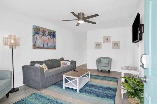 325 E 22nd Ave Unit 8, Gulf Shores, AL 36542 - living area featuring wood finished floors, ceiling fan, and baseboards