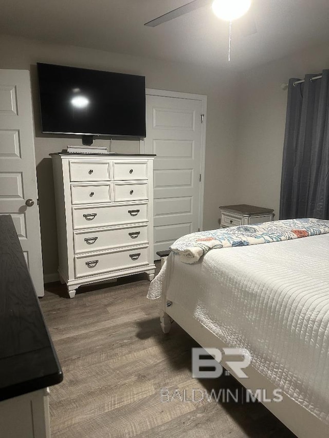 bedroom with wood finished floors and a ceiling fan