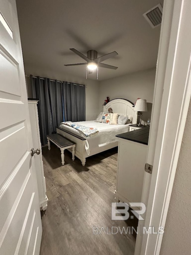 bedroom featuring visible vents, ceiling fan, and wood finished floors