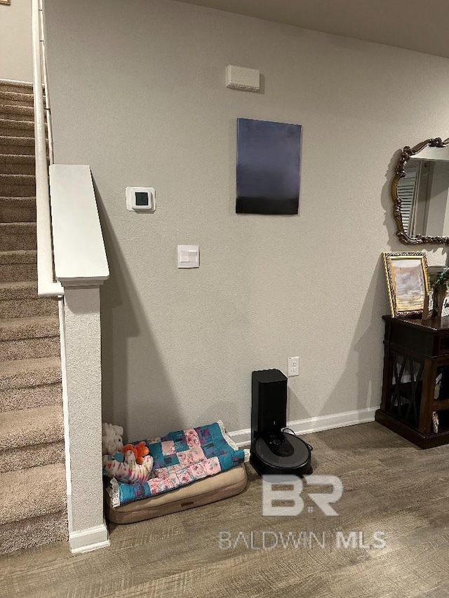 interior space featuring baseboards and stairs