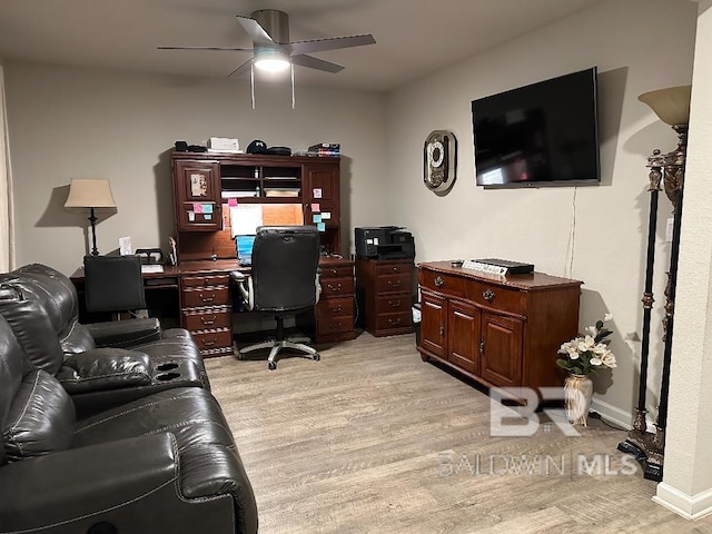 office area with ceiling fan, baseboards, and light wood-style floors