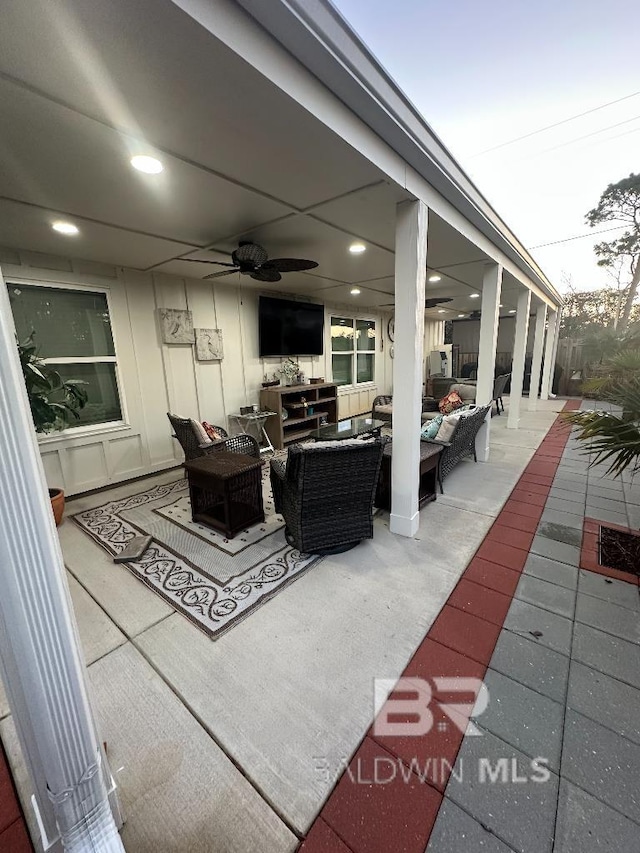 view of patio / terrace with ceiling fan and an outdoor living space