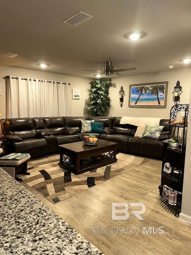 living room featuring visible vents and recessed lighting