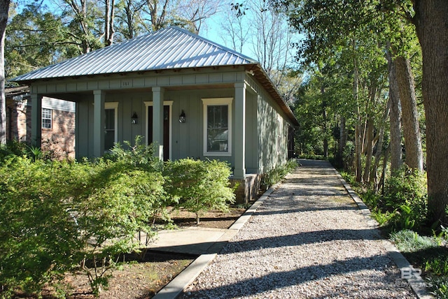 view of side of home with covered porch