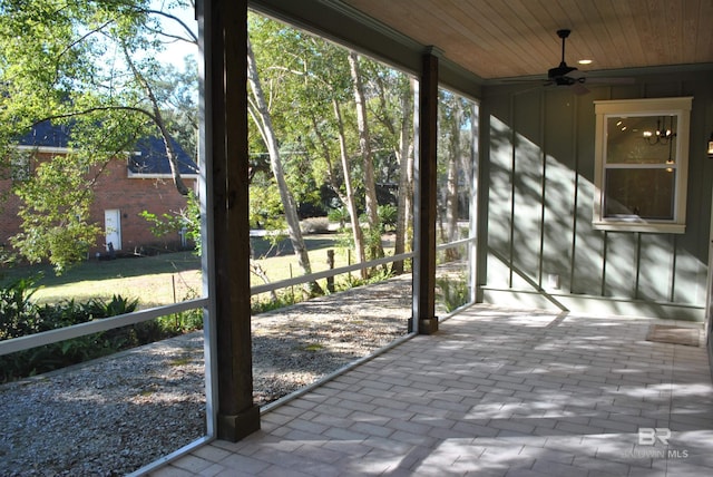 unfurnished sunroom with ceiling fan and wood ceiling