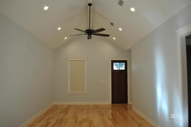 foyer entrance with ceiling fan, light hardwood / wood-style flooring, and vaulted ceiling