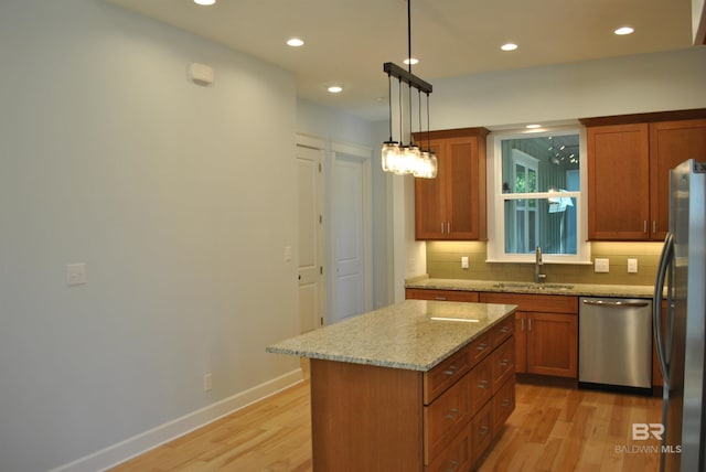 kitchen with sink, a center island, stainless steel appliances, pendant lighting, and decorative backsplash