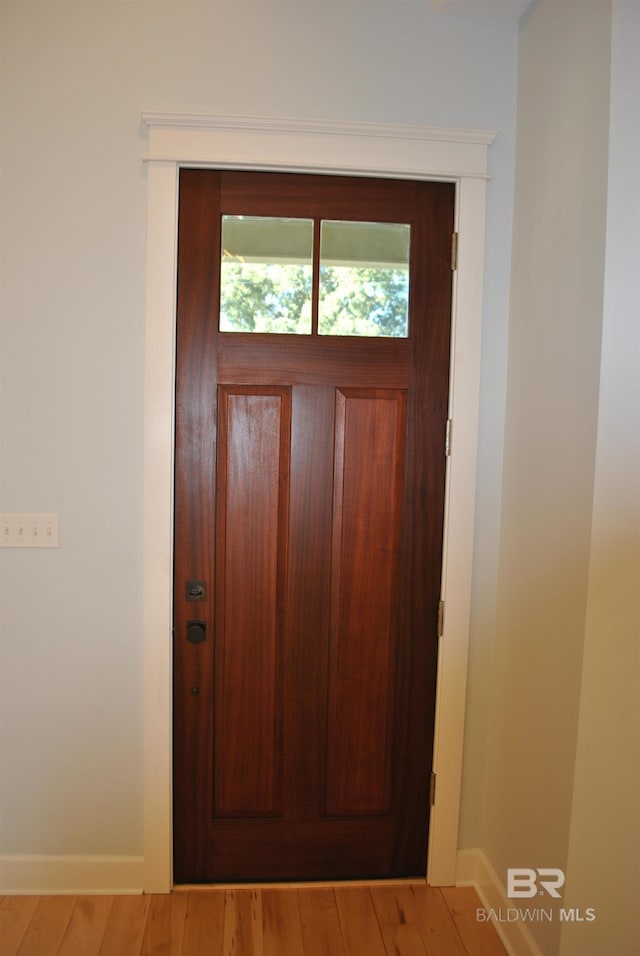 entryway with wood-type flooring