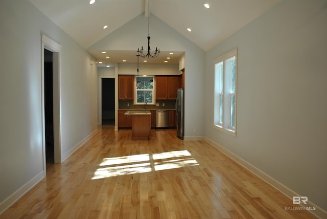 kitchen featuring a center island, light hardwood / wood-style flooring, pendant lighting, and appliances with stainless steel finishes