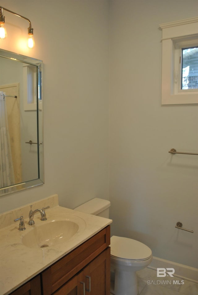 bathroom with tile patterned floors, vanity, and toilet