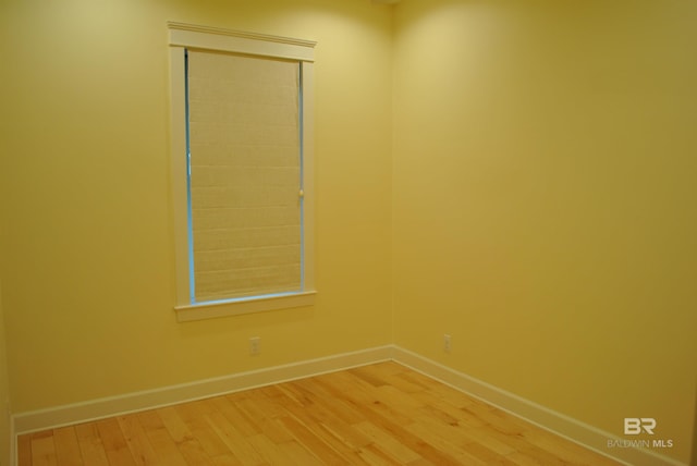 unfurnished room with hardwood / wood-style flooring