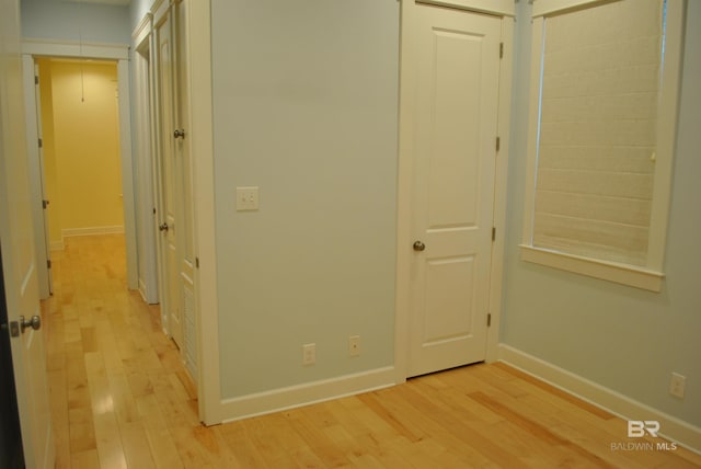 corridor with light hardwood / wood-style flooring