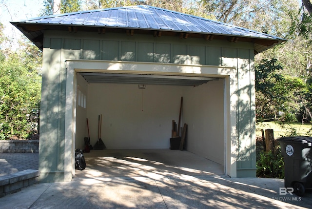 view of side of home featuring a garage and an outdoor structure