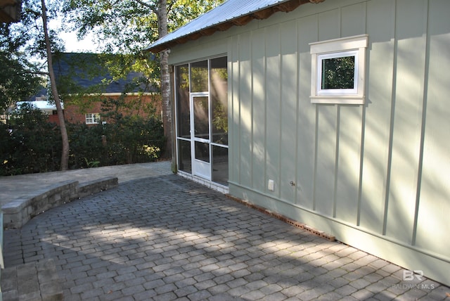 view of side of property with a patio area