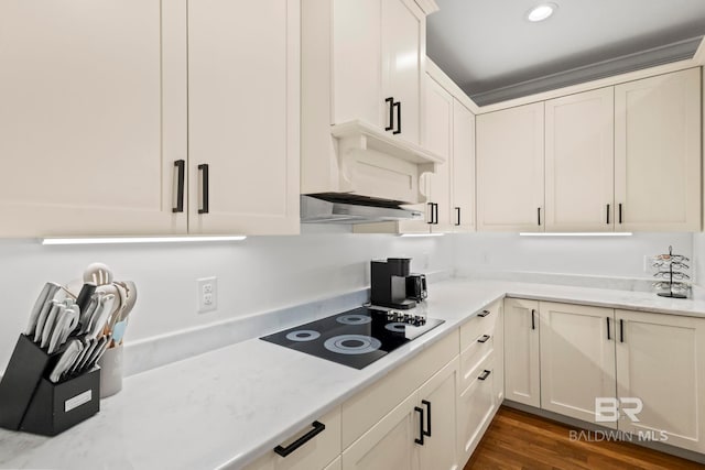 kitchen featuring under cabinet range hood, dark wood finished floors, white cabinetry, recessed lighting, and black electric cooktop