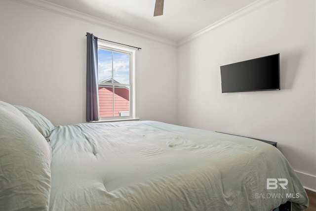 bedroom featuring a ceiling fan and crown molding