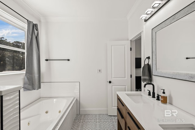 bathroom with tile patterned flooring, crown molding, baseboards, a whirlpool tub, and vanity