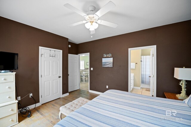 446 Harbor Light Cir, Gulf Shores, AL 36542 - bedroom with baseboards, light wood-style floors, ensuite bathroom, and a ceiling fan