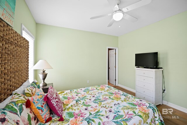 446 Harbor Light Cir, Gulf Shores, AL 36542 - bedroom with wood finished floors, ceiling fan, and baseboards