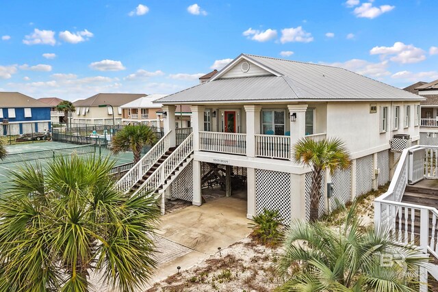 446 Harbor Light Cir, Gulf Shores, AL 36542 - back of house with a residential view, a carport, stairway, metal roof, and fence