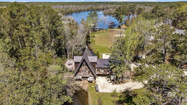 birds eye view of property with a water view and a wooded view