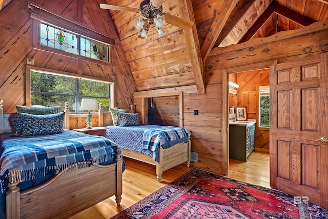 bedroom featuring high vaulted ceiling, wood walls, hardwood / wood-style flooring, and beamed ceiling